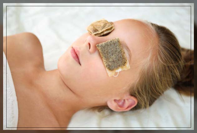 woman removing dark circles using tea bags on eyes