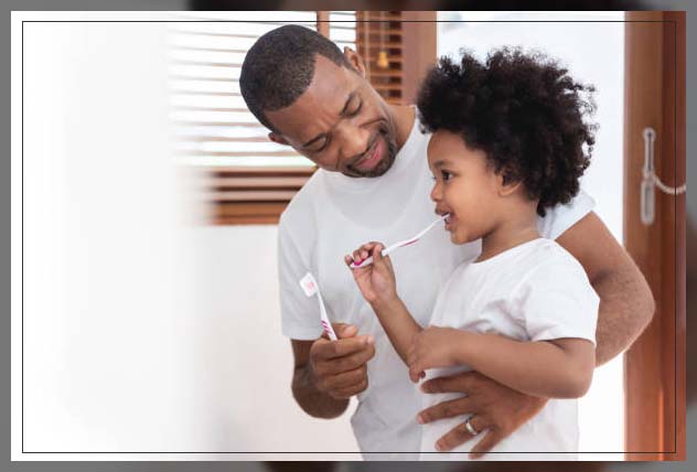 father and son brushing healthy teeth 