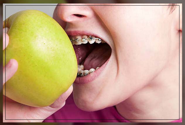 woman trying to eat an apple 