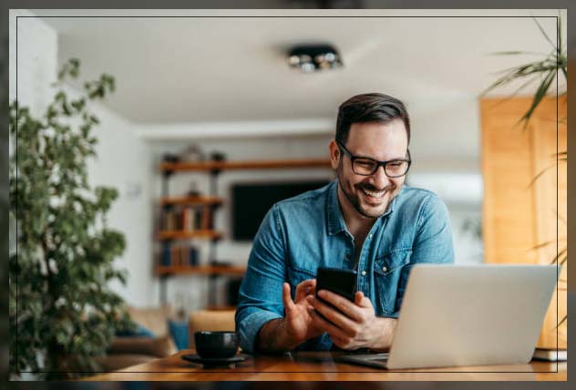 man keep smiling by watching fun show and chatting with friend