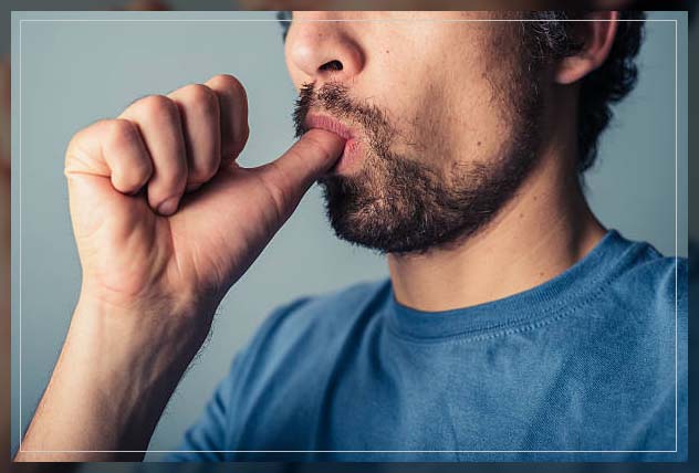 adult man putting his thumb in mouth