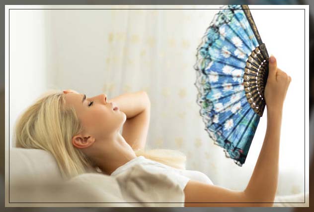 woman fanning herself in hot weather