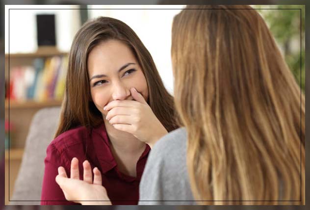 woman hiding smile because of imperfect teeth