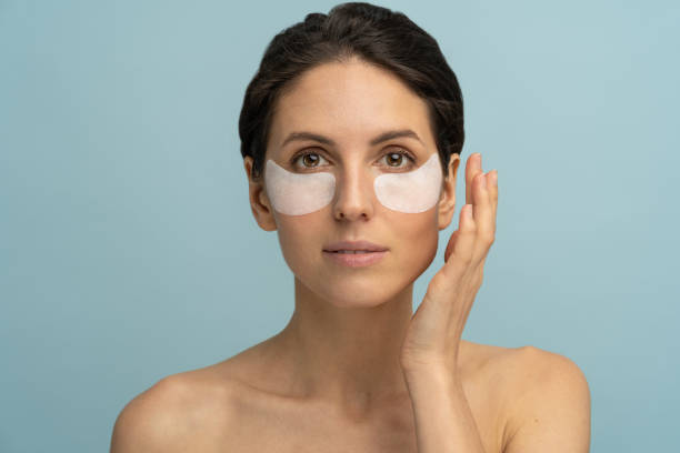 woman applying eye patches