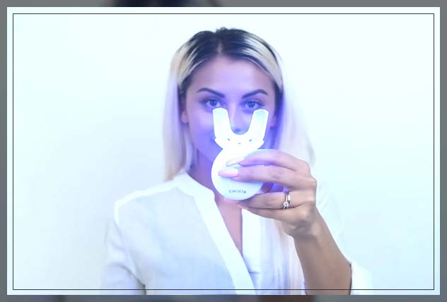 woman holding a mouth tray thinking about using it