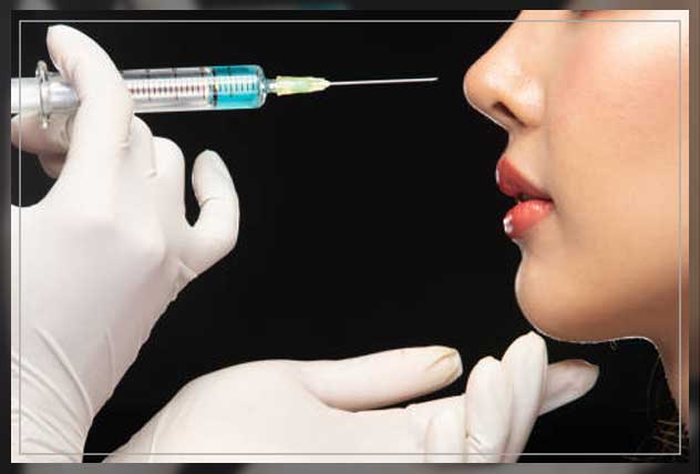 doctor closing on needle on woman's face